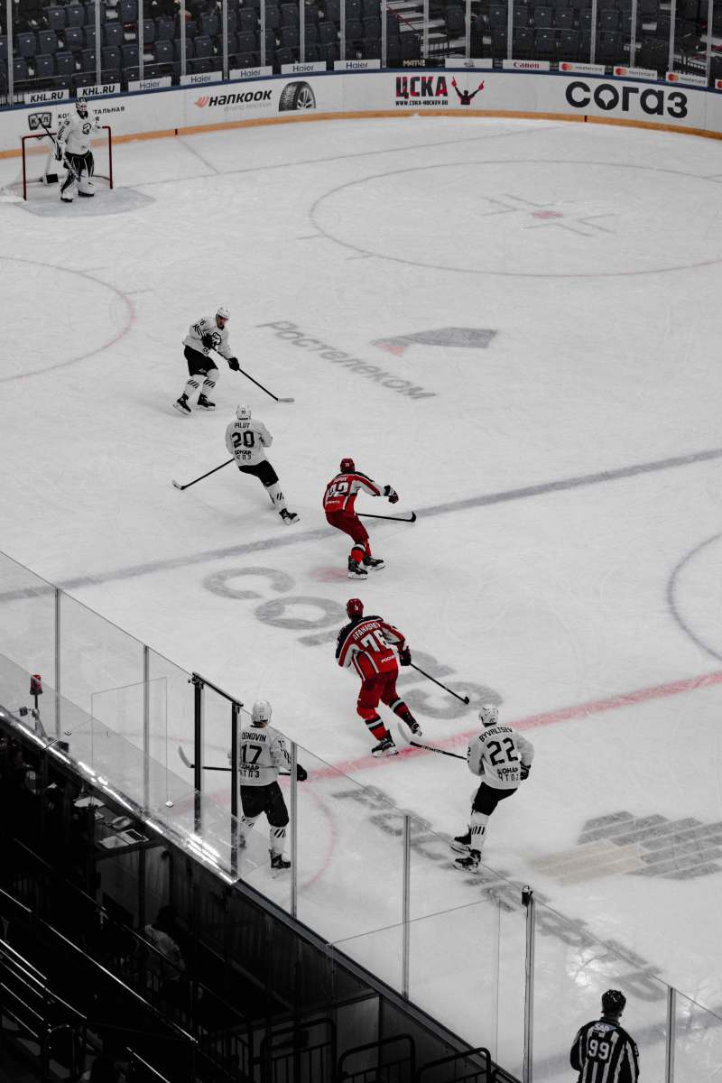 ice hockey 2 men in red and white ice hockey jersey playing on ice hockey field grey